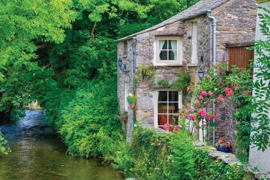 A set of UPVC windows on a country home sat on a riverbank